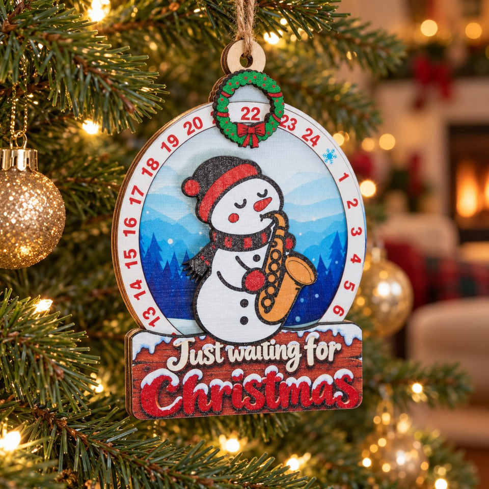 Snowman Saxophone wooden Christmas countdown hanging on the Christmas tree with warm surrounding lights