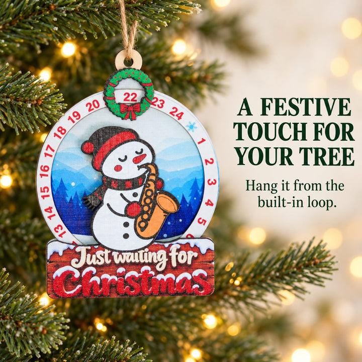 Snowman Saxophone wooden Christmas countdown hung through its built-in wooden hole on a Christmas tree