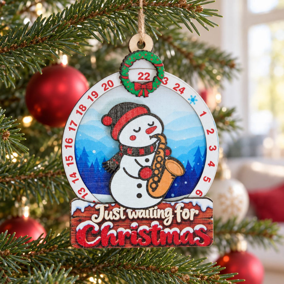 Snowman Saxophone wooden Christmas countdown hanging on the Christmas tree in daylight