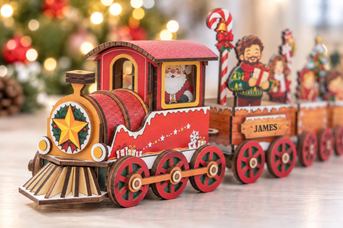 Close-up of the Santa locomotive showing its star and holly front, slatted cowcatcher, red wheels and layered wooden construction