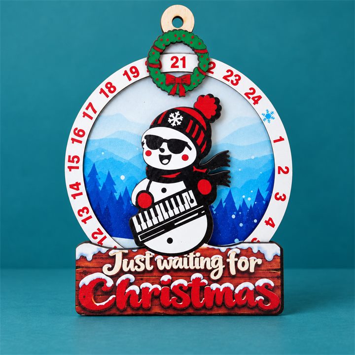 Snowman Keyboard Wooden Christmas Countdown Plaque on a petrol teal studio background